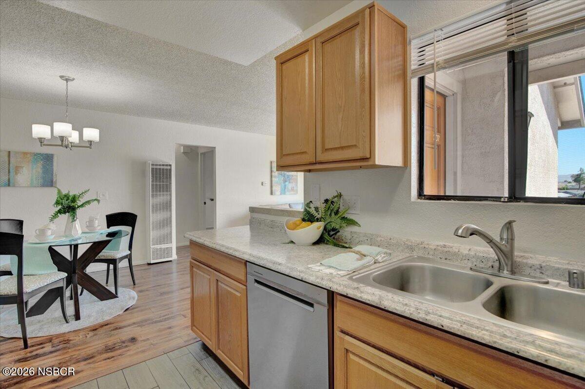 3400 Santa Maria Way, Unit 207B Santa Maria, CA 93455 - Photo 20 of 50 a kitchen with stainless steel appliances granite countertop a sink dishwasher and cabinets with wooden floor