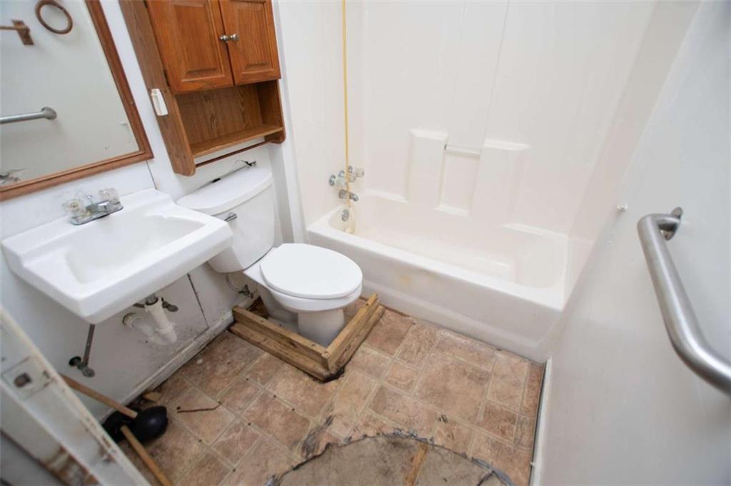 7104 Miller Street Lithia Springs, GA 30122 - Photo 13 of 18 a bathroom with a sink toilet mirror and vanity
