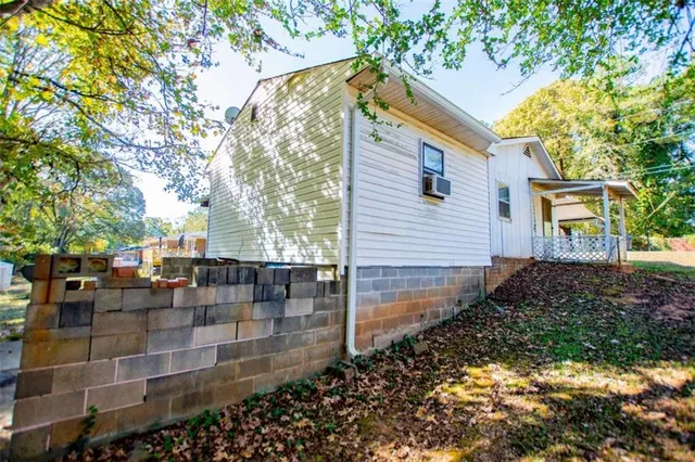 a backyard of a house with table and chairs
