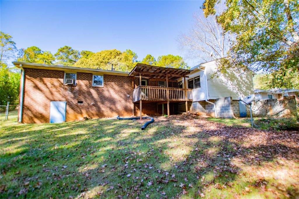 7104 Miller Street Lithia Springs, GA 30122 - Photo 18 of 18 a view of a backyard with a plants and large tree