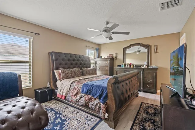 a bedroom with a bed a couch and dresser