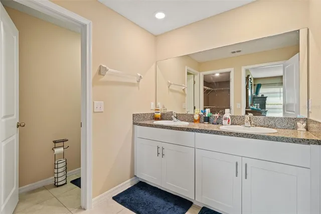 a bathroom with a granite countertop sink mirror and vanity