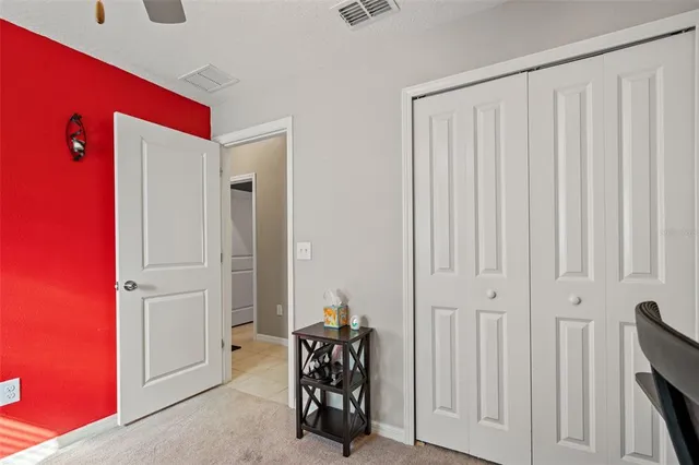a bathroom with a granite countertop sink mirror vanity and toilet