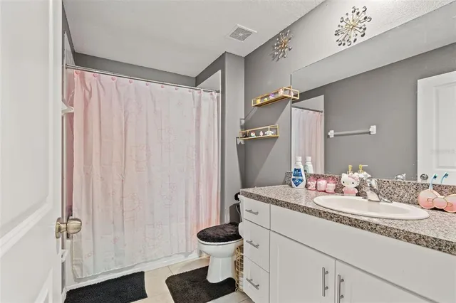 a bedroom with a bed and a ceiling fan