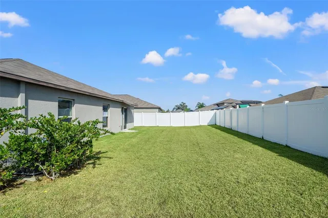an aerial view of residential houses with outdoor space and river