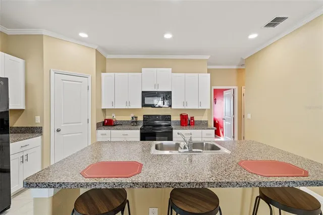 a kitchen with granite countertop a sink and cabinets