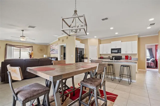 a view of a dining room with furniture and a chandelier