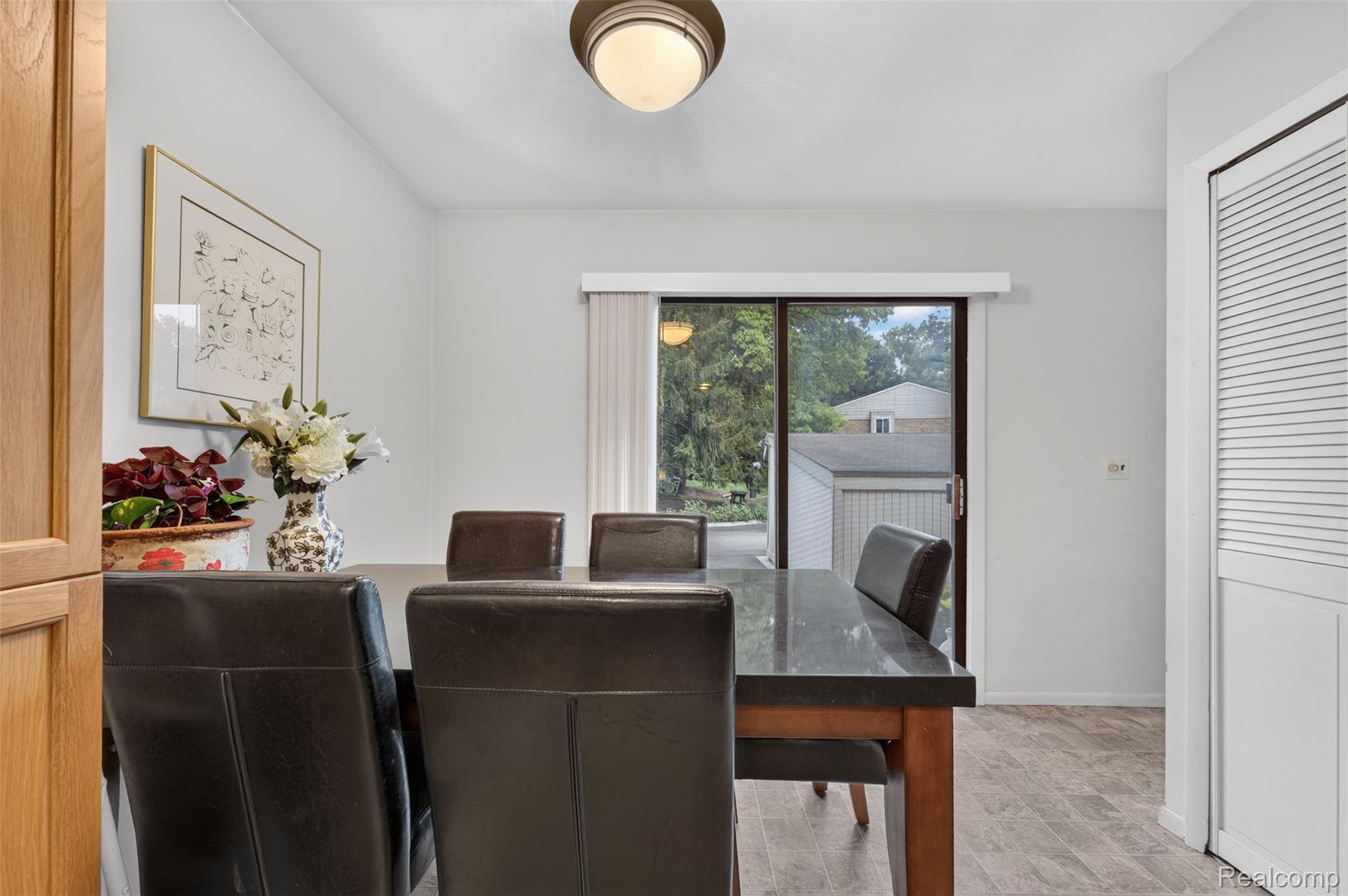 1439 Oakbrook E Drive Rochester, MI 48307 - Photo 14 of 68 Recessed ceiling light fixture, sliding glass door, light wood-finish flooring, white louvered bifold door