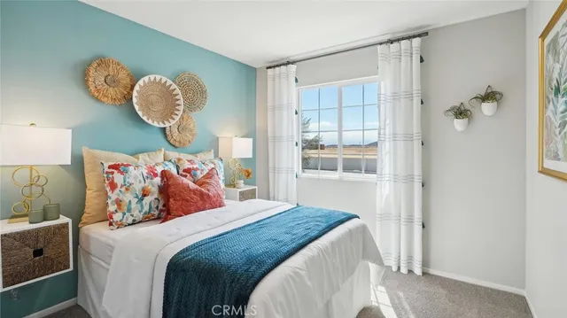 a bedroom with a large bed and a window