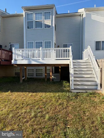 a view of a house with backyard and deck