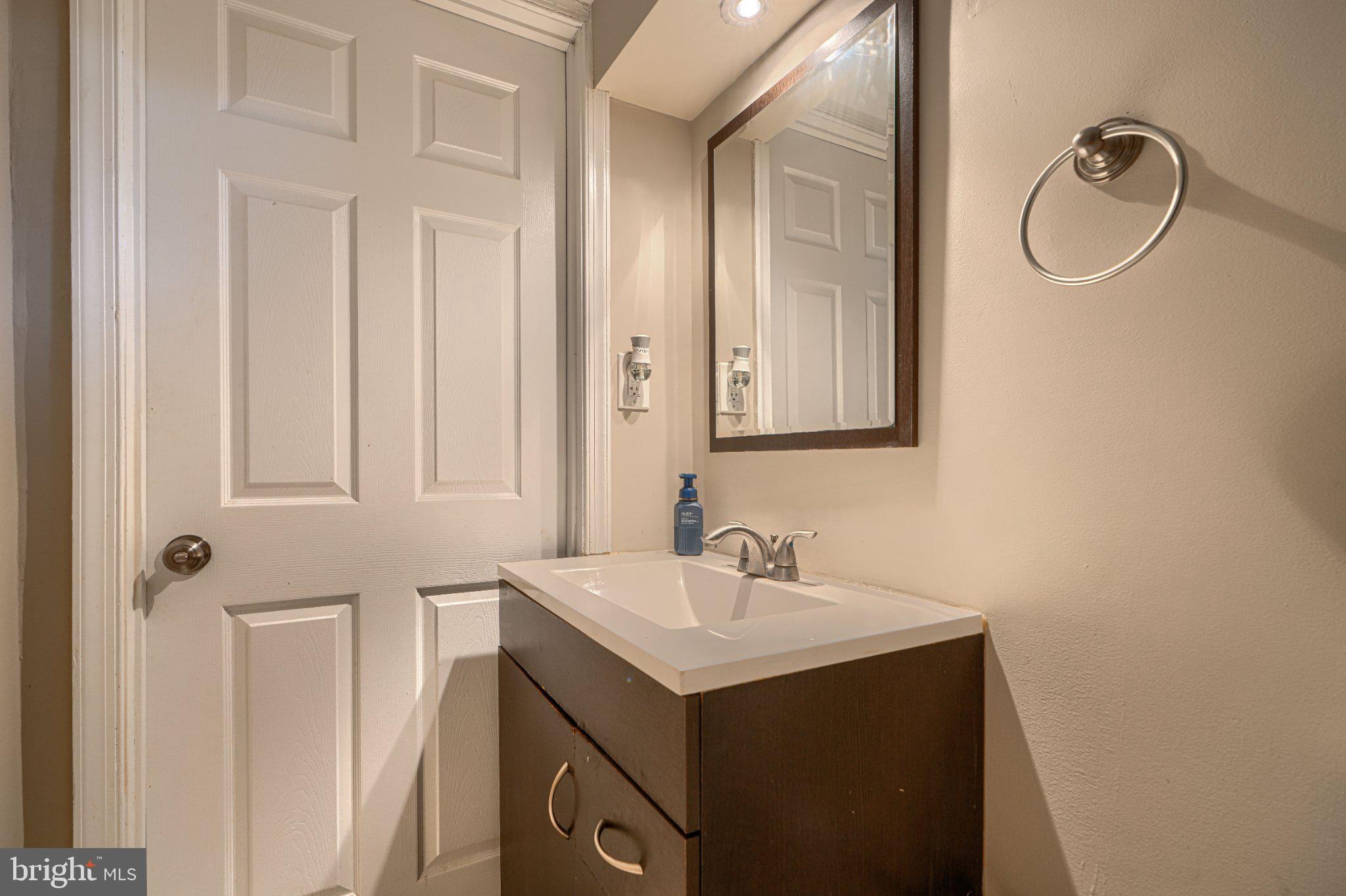 3708 Cassen Road Randallstown, MD 21133 - Photo 33 of 38 a bathroom with a sink and a mirror