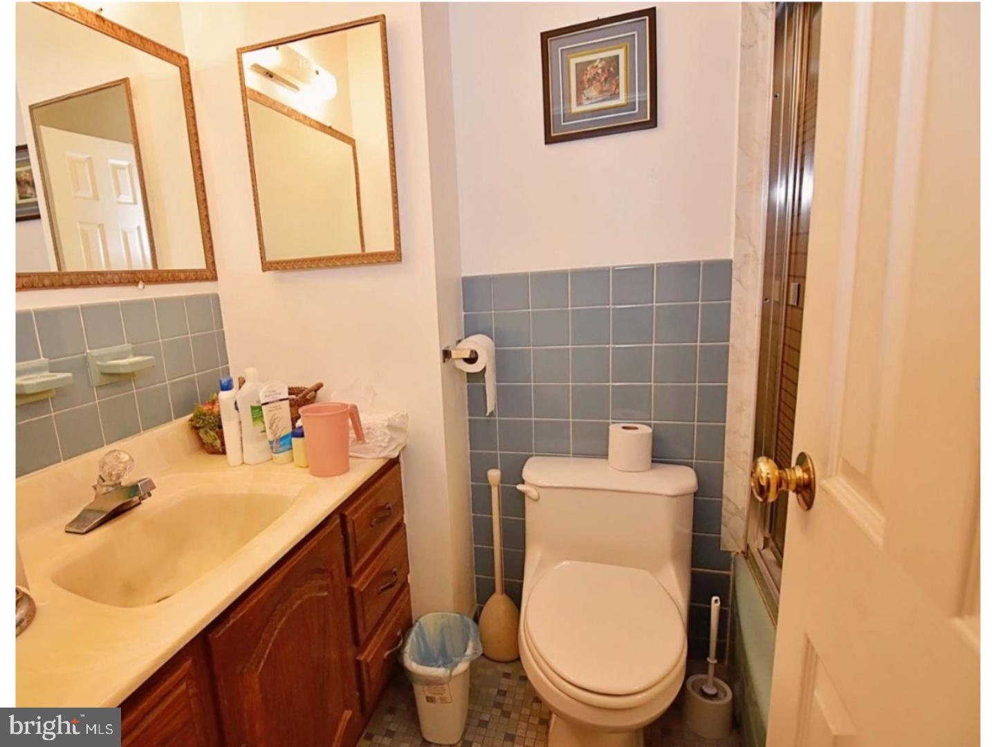 1131 Layton Road Philadelphia, PA 19115 - Photo 14 of 24 a bathroom with a sink a toilet and a mirror