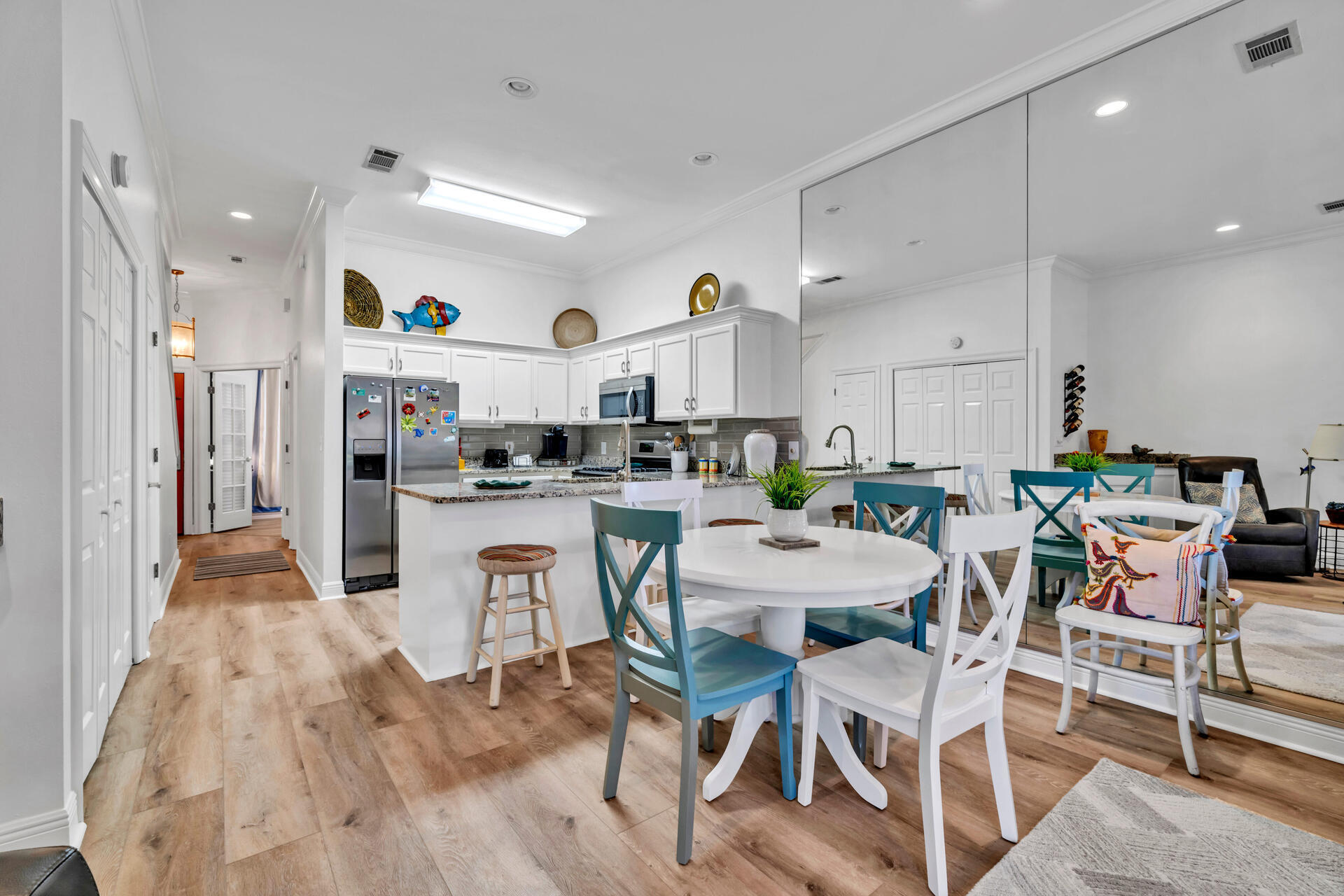 64 Vantage Point, Unit 64 Miramar Beach, FL 32550 - Photo 13 of 38 a kitchen with stainless steel appliances kitchen island granite countertop a table chairs and a refrigerator