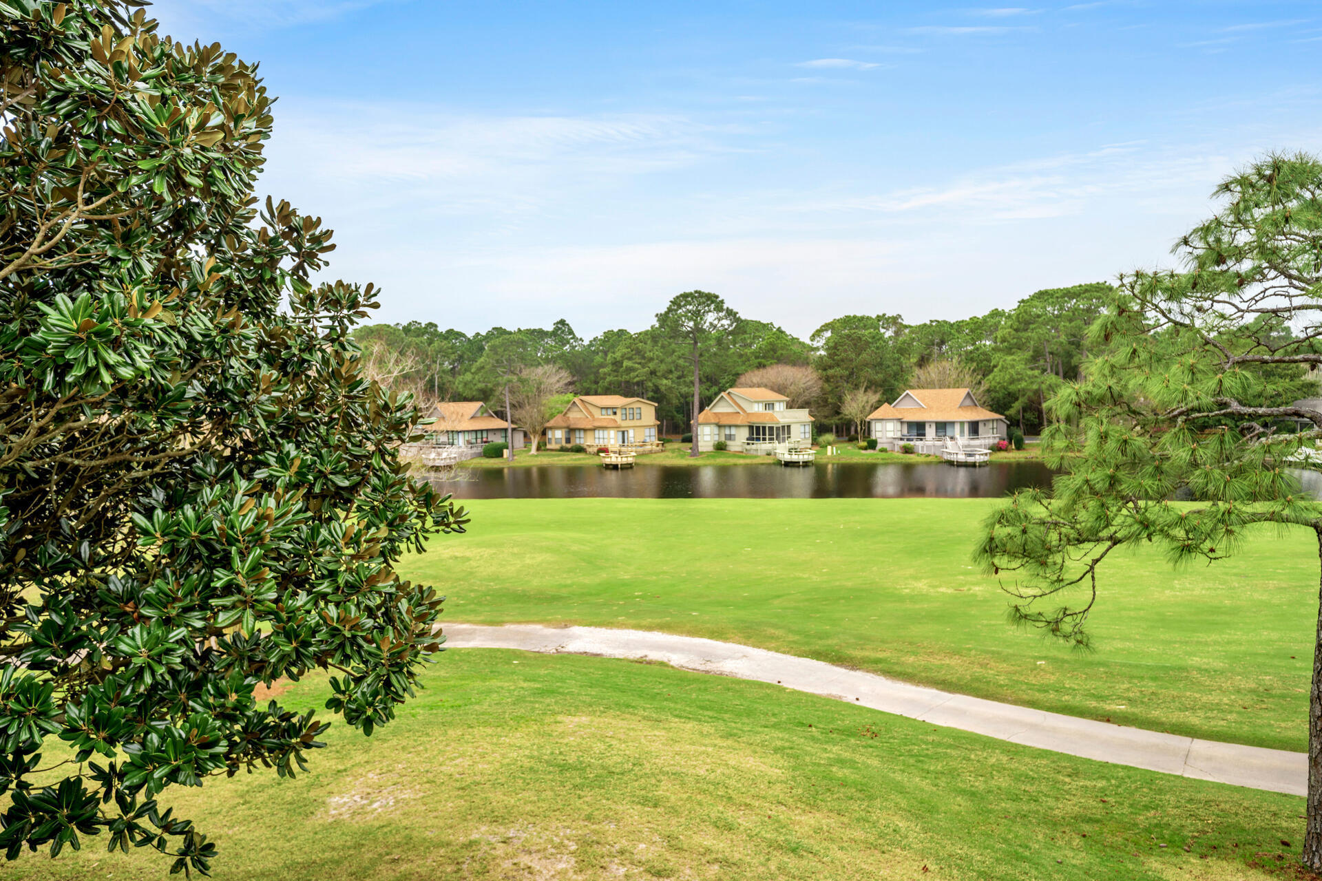64 Vantage Point, Unit 64 Miramar Beach, FL 32550 - Photo 37 of 38 a view of a golf course with a lake