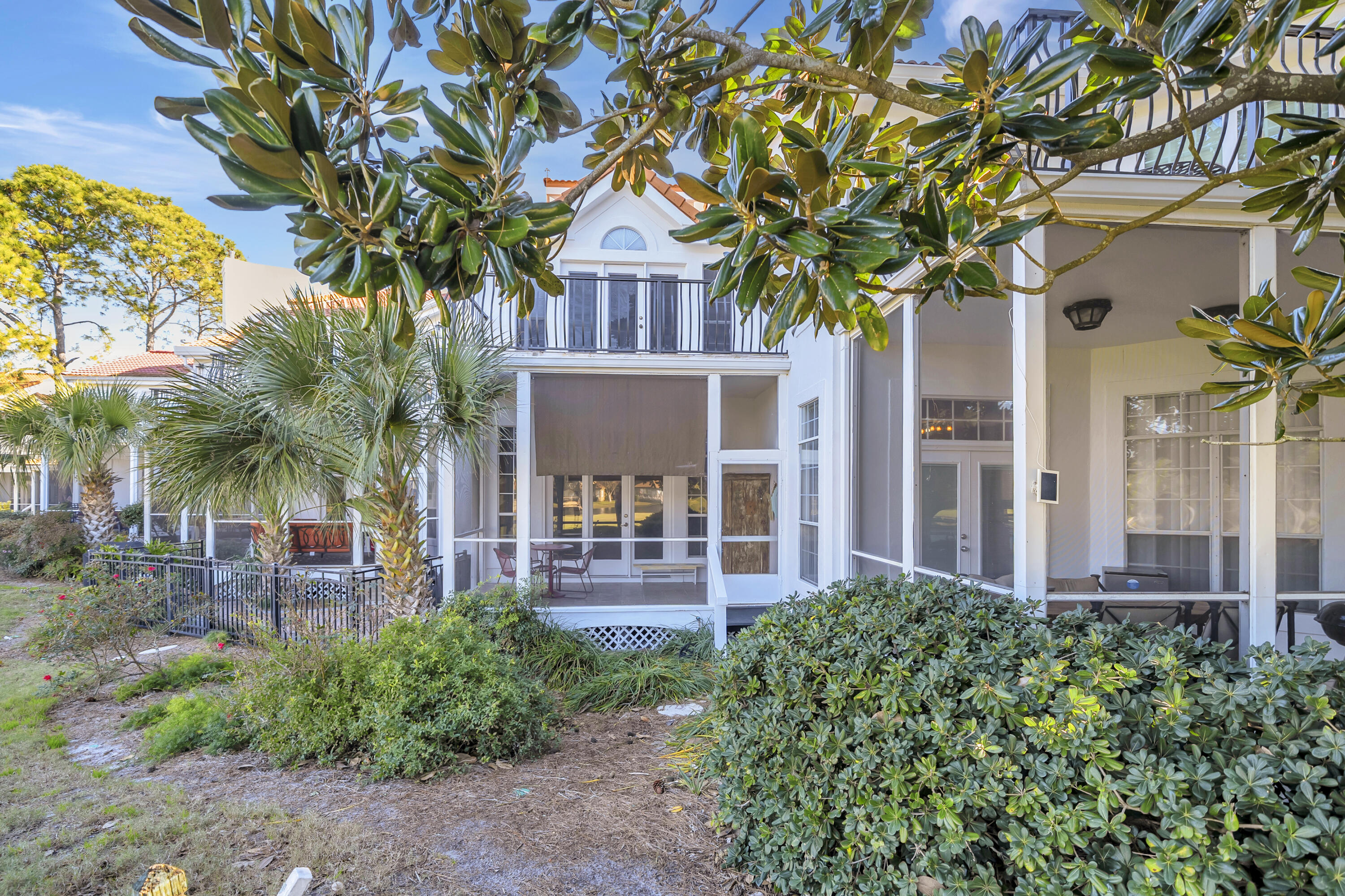 64 Vantage Point, Unit 64 Miramar Beach, FL 32550 - Photo 4 of 38 a front view of a house with a garden