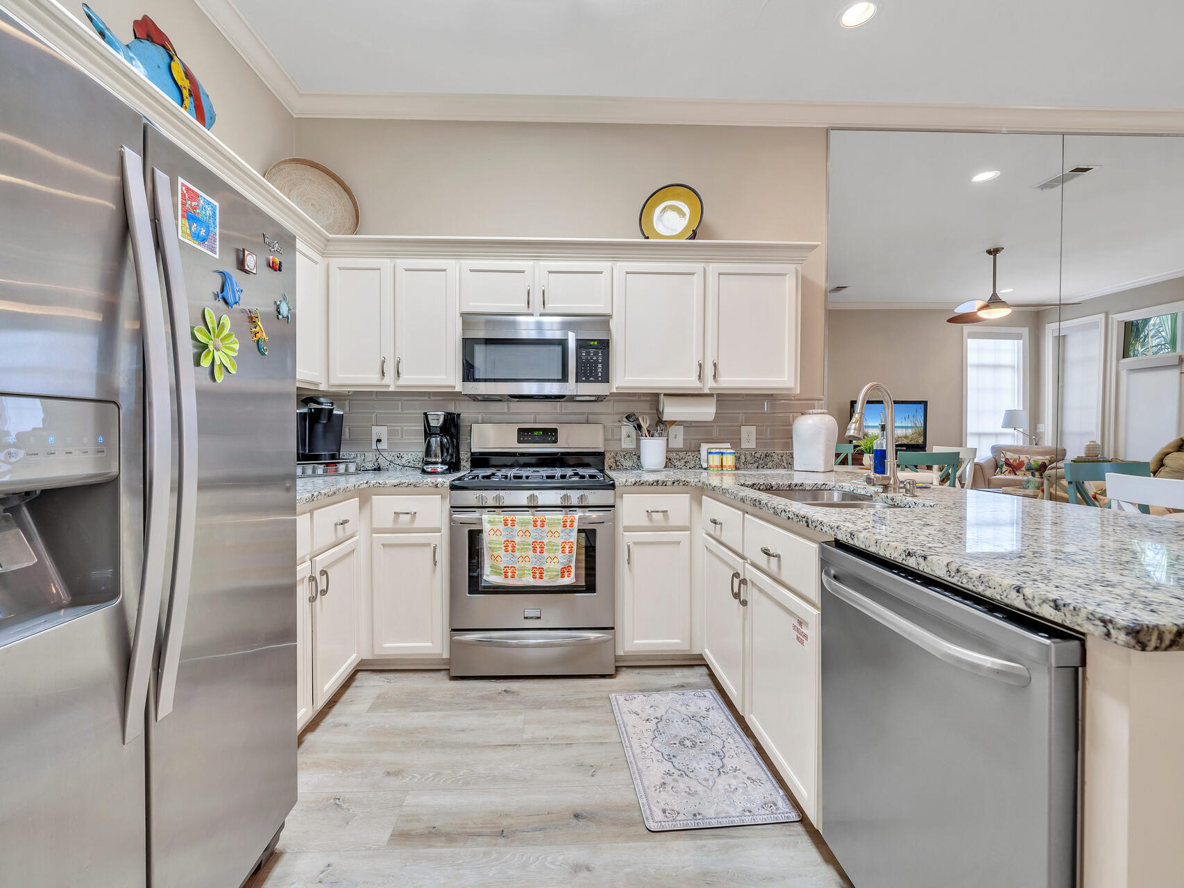 64 Vantage Point, Unit 64 Miramar Beach, FL 32550 - Photo 10 of 38 a kitchen with kitchen island granite countertop a sink stainless steel appliances and a counter top space
