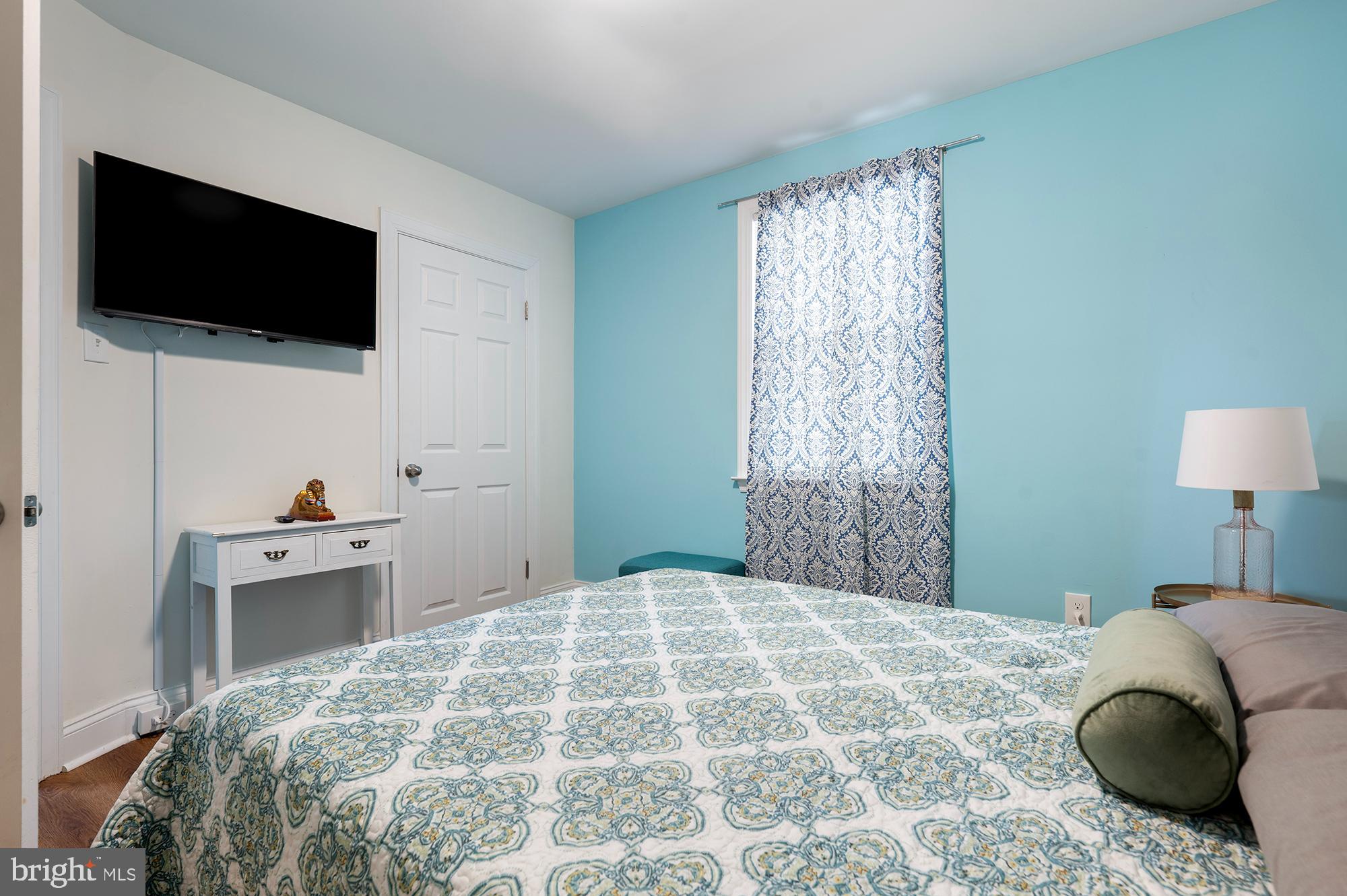 104 Wilson Boulevard Southwest Glen Burnie, MD 21061 - Photo 12 of 23 a bedroom with a bed and a flat screen tv