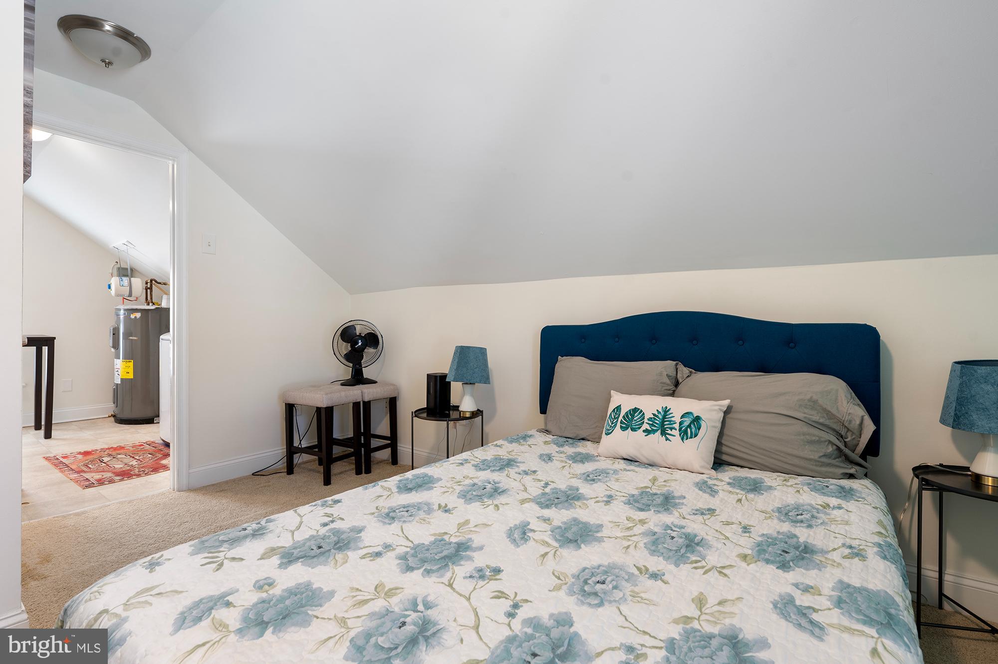 104 Wilson Boulevard Southwest Glen Burnie, MD 21061 - Photo 13 of 23 a bedroom with a large bed and a window