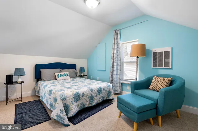 a bedroom with a bed and a couch