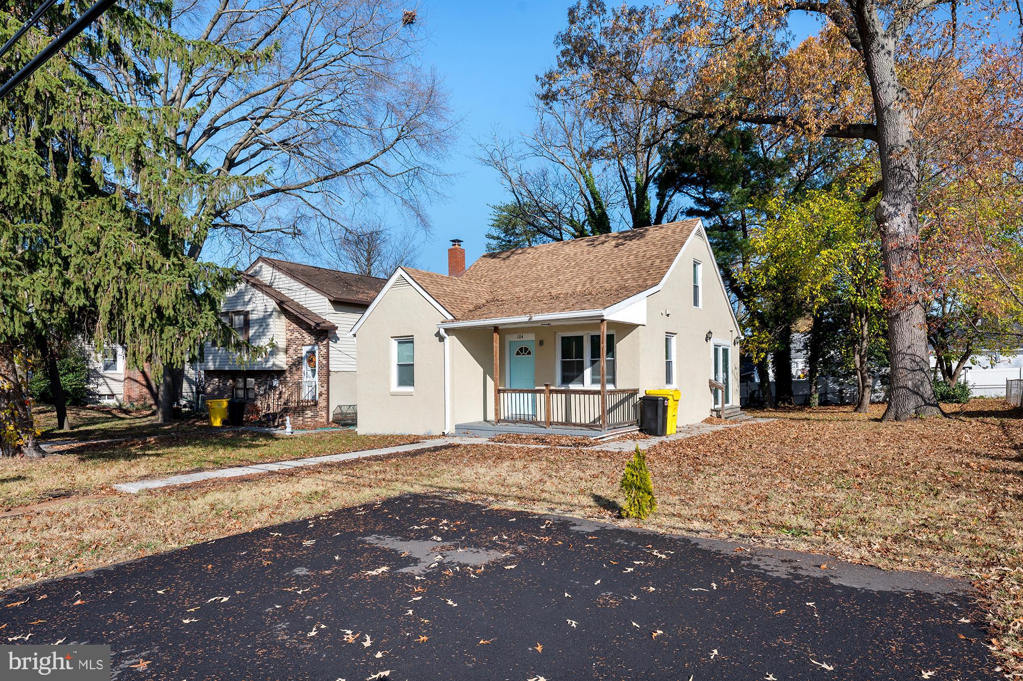 104 Wilson Boulevard Southwest Glen Burnie, MD 21061 - Photo 23 of 23 a view of a white house with a large tree in front of it