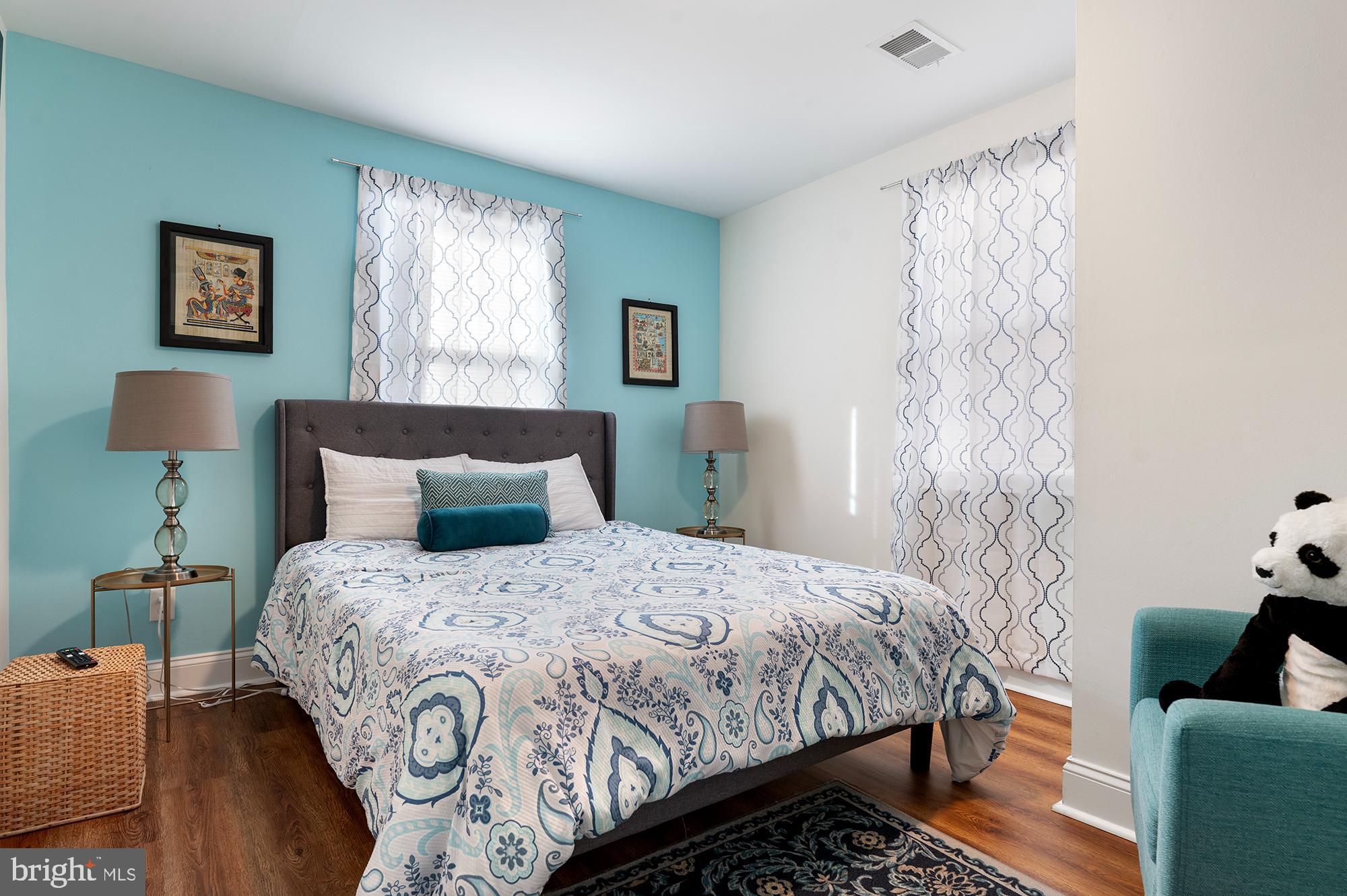 104 Wilson Boulevard Southwest Glen Burnie, MD 21061 - Photo 7 of 23 a bedroom with a bed and a lamp with window