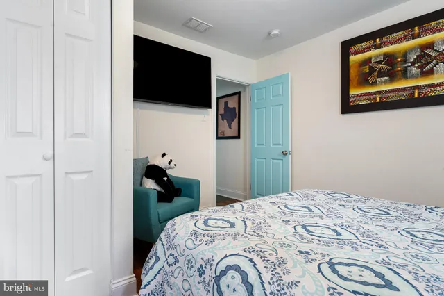 a bedroom with a bed and a flat screen tv