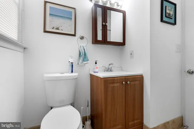 a bathroom with a toilet a sink and mirror
