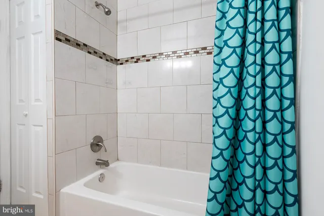 a bathroom with a bathtub and shower