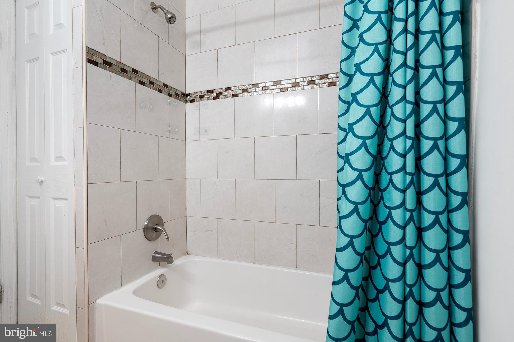 104 Wilson Boulevard Southwest Glen Burnie, MD 21061 - Photo 10 of 23 a bathroom with a bathtub and shower