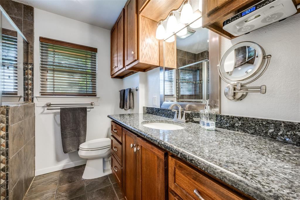 1027 Stanley Street Denton, TX 76201 - Photo 23 of 38 UPDATED PRIMARY BATHROOM~GRANITE COUNTERTOPS~OVERSIZED WALK IN SHOWER~