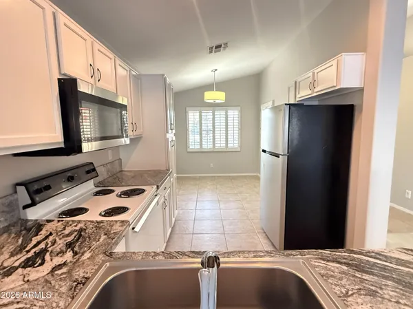 a kitchen with a stove a sink and a microwave