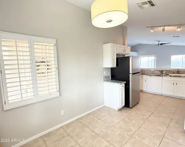 a kitchen with stainless steel appliances a refrigerator and a stove top oven