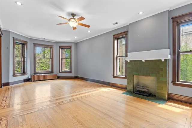 a view of a room with wooden floor and windows