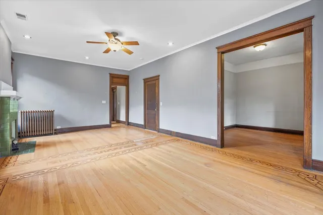 a view of an empty room with a fireplace and a window