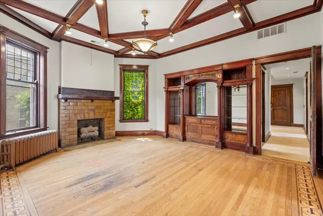 a view of empty room with wooden floor