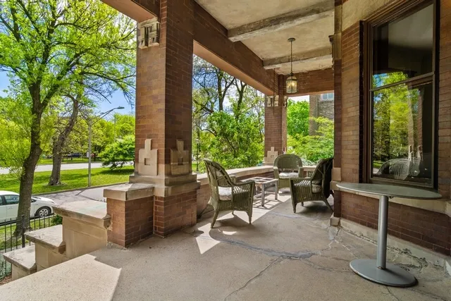 a view of an empty room with window and fire place