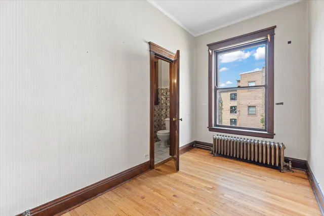 an empty room with mirror and entrance