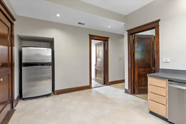 a kitchen with stainless steel appliances granite countertop a refrigerator and a stove top oven