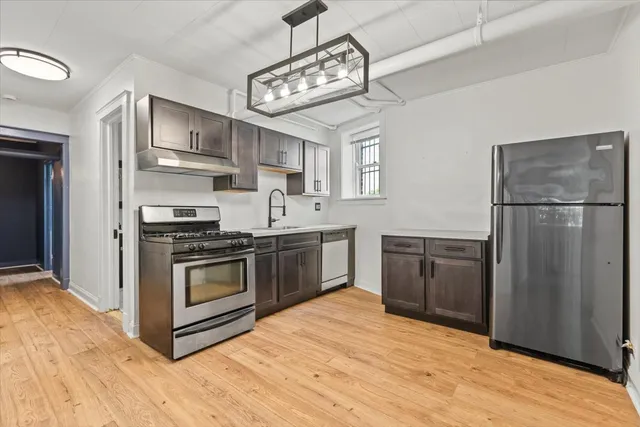an empty room with a window and ceiling fan