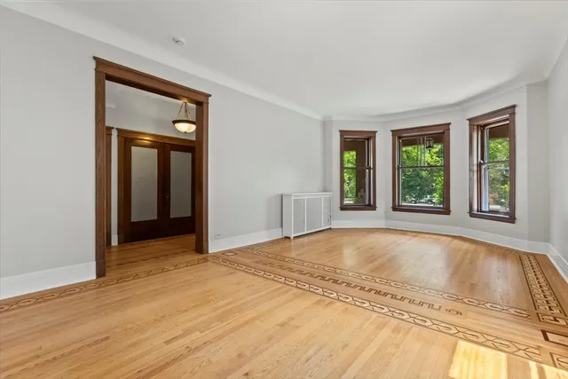 a view of a livingroom with wooden floor and window