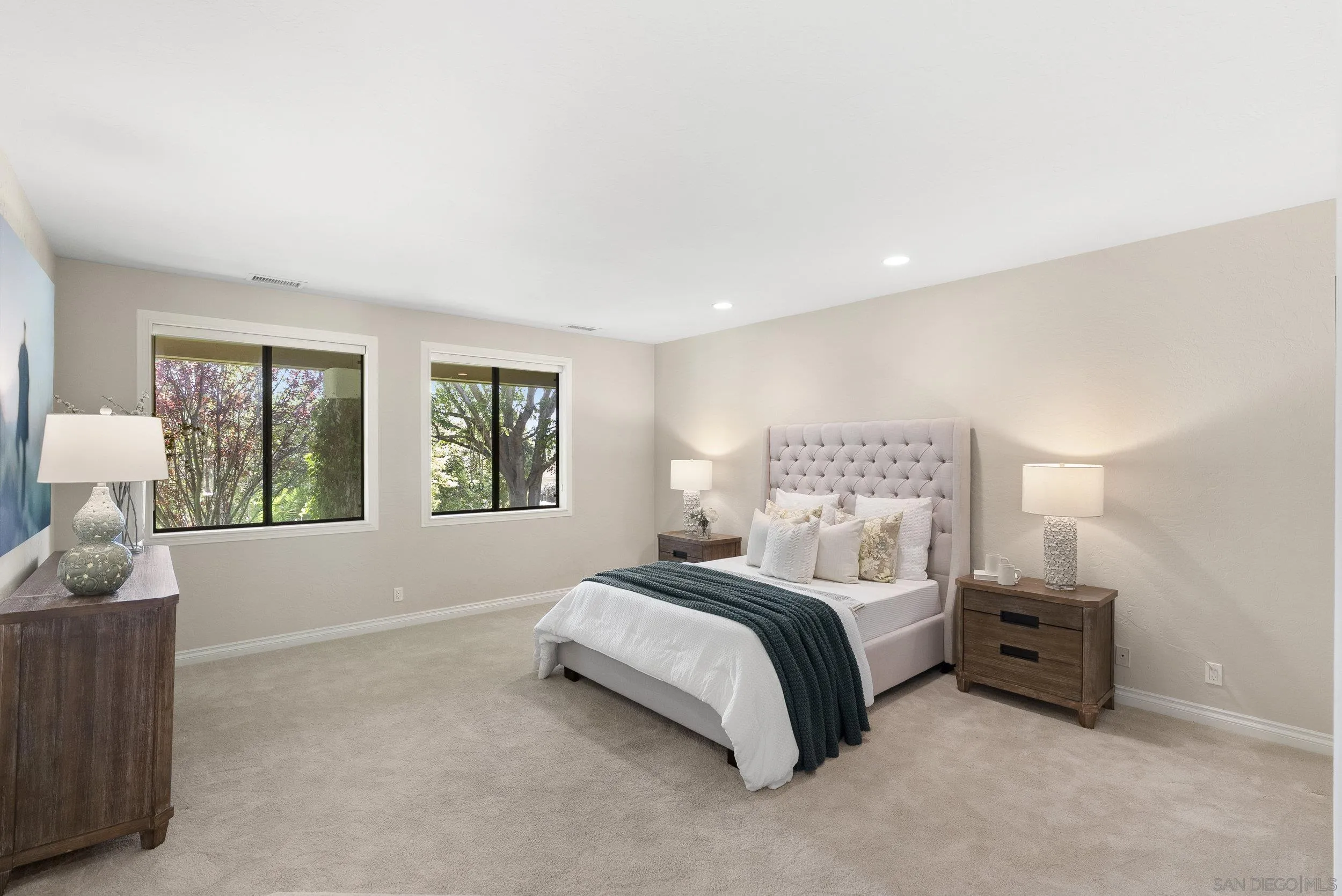 17207 El Caporal Rancho Santa Fe, CA 92067 - Photo 11 of 19 a spacious bedroom with a bed and a large window