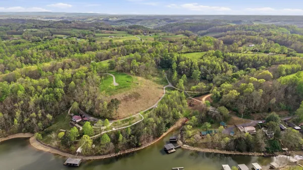 a view of a water fountain with large trees