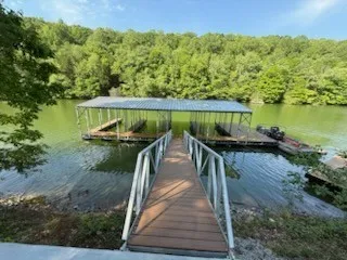 a view of a wooden deck and lake view