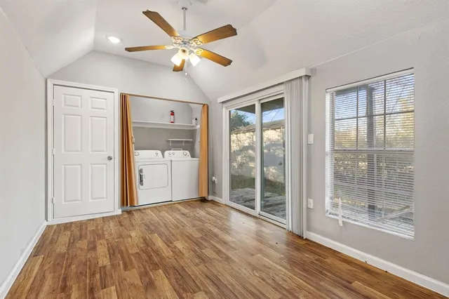 a view of a livingroom with wooden floor and a ceiling fan