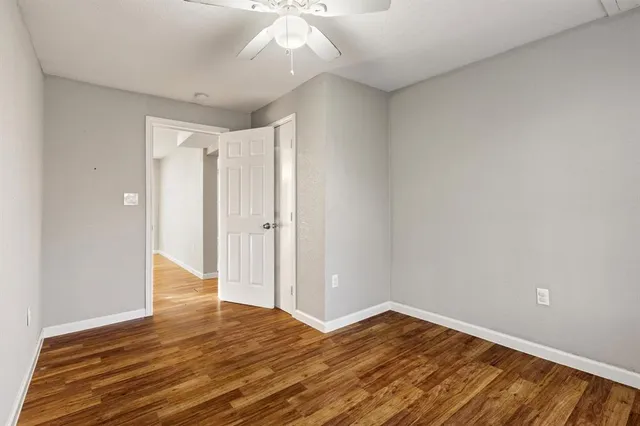 a view of a room with wooden floor