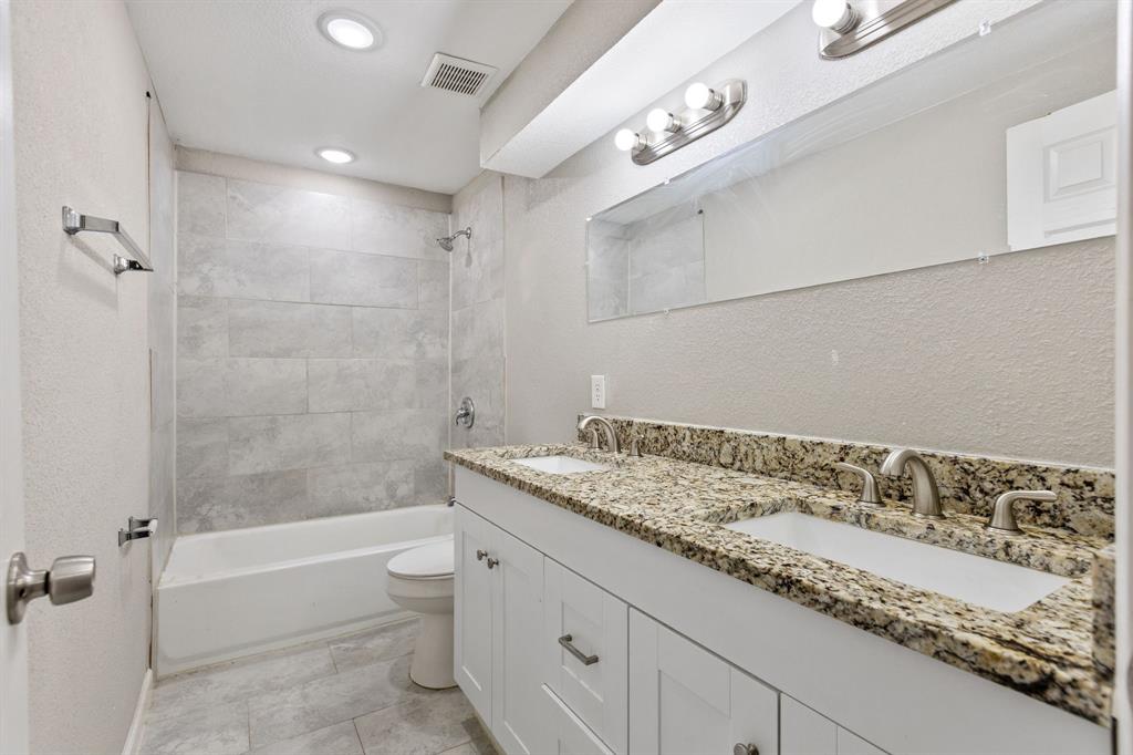 202 South Dunbar Lane Emory, TX 75440 - Photo 16 of 25 a bathroom with a granite countertop sink a toilet and bathtub
