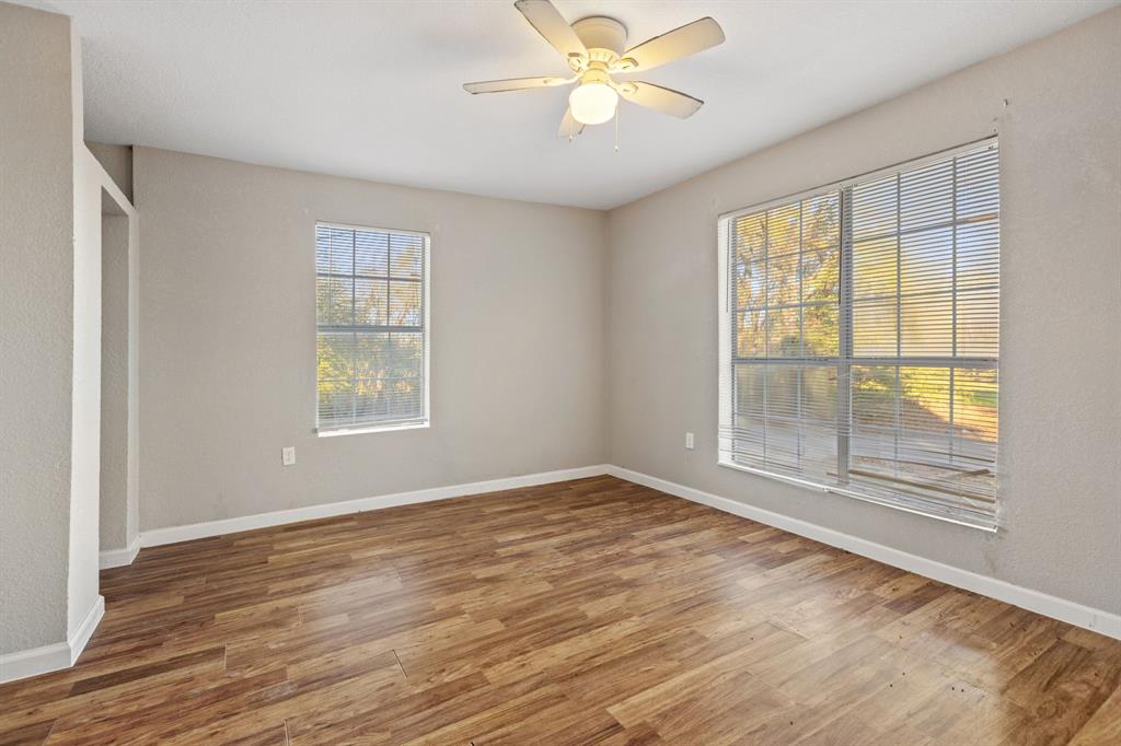 202 South Dunbar Lane Emory, TX 75440 - Photo 20 of 25 a view of an empty room with a window and wooden floor