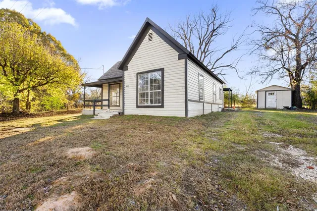 a view of a yard with a house and a tree