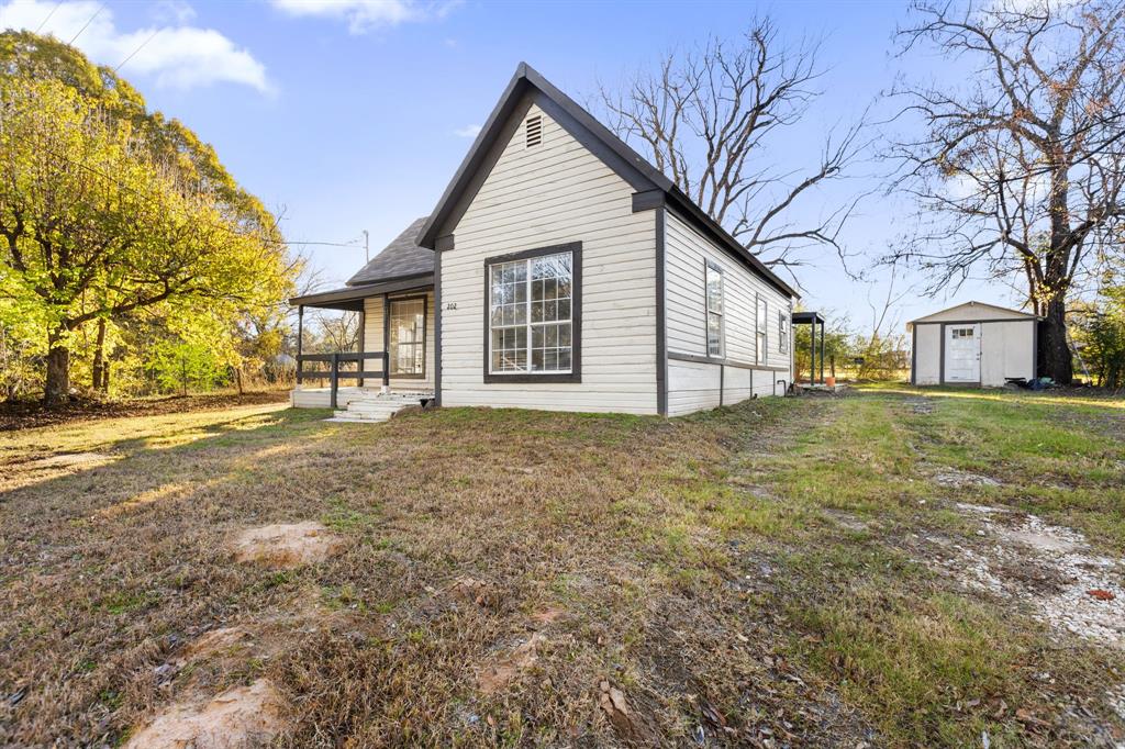 202 South Dunbar Lane Emory, TX 75440 - Photo 3 of 25 a view of a yard with a house and a tree