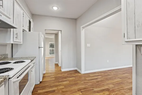 a kitchen with a stove and a white refrigerator